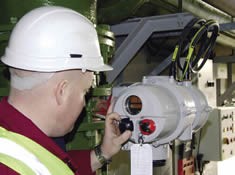 A Rotork engineer locally operates a newly installed Rotork IQT actuator during commissioning.